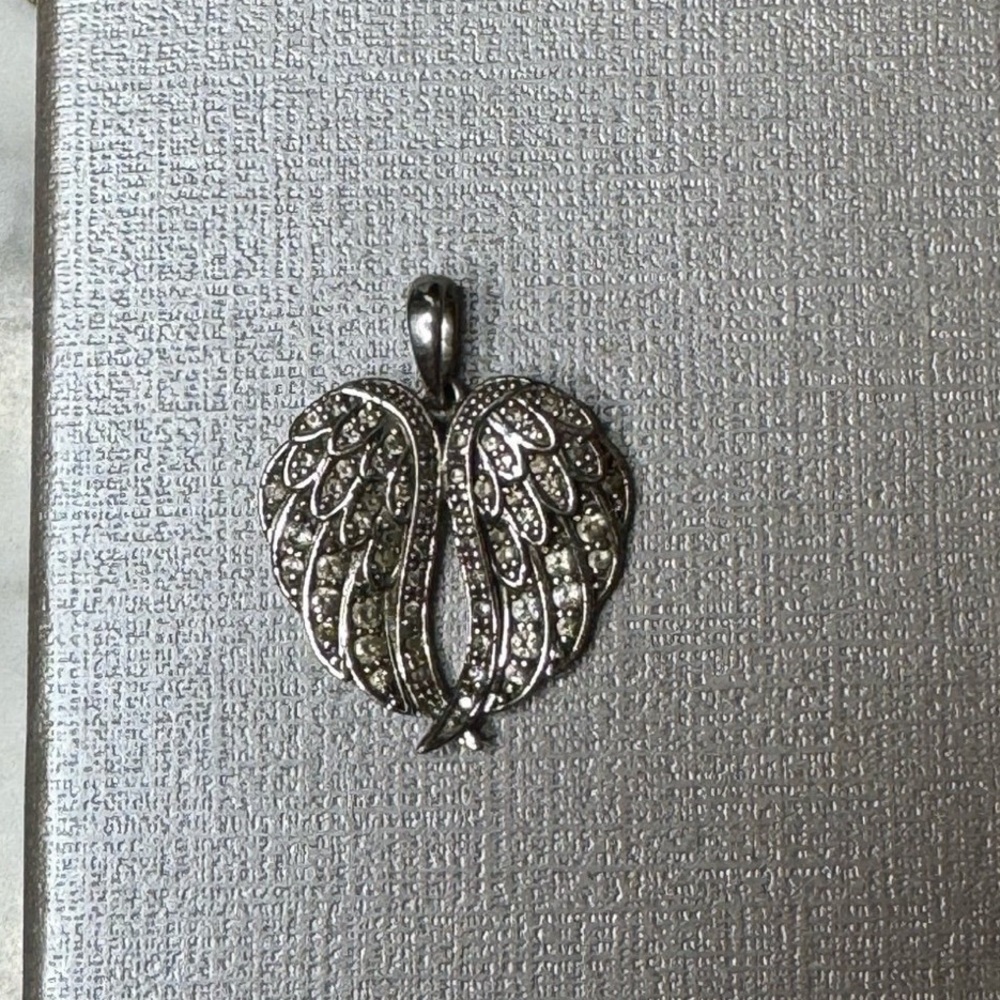Chuck Clemency White zircon angel wing pendant
